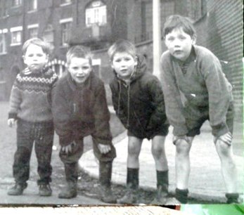 Young boys playing in the street in the 1950s